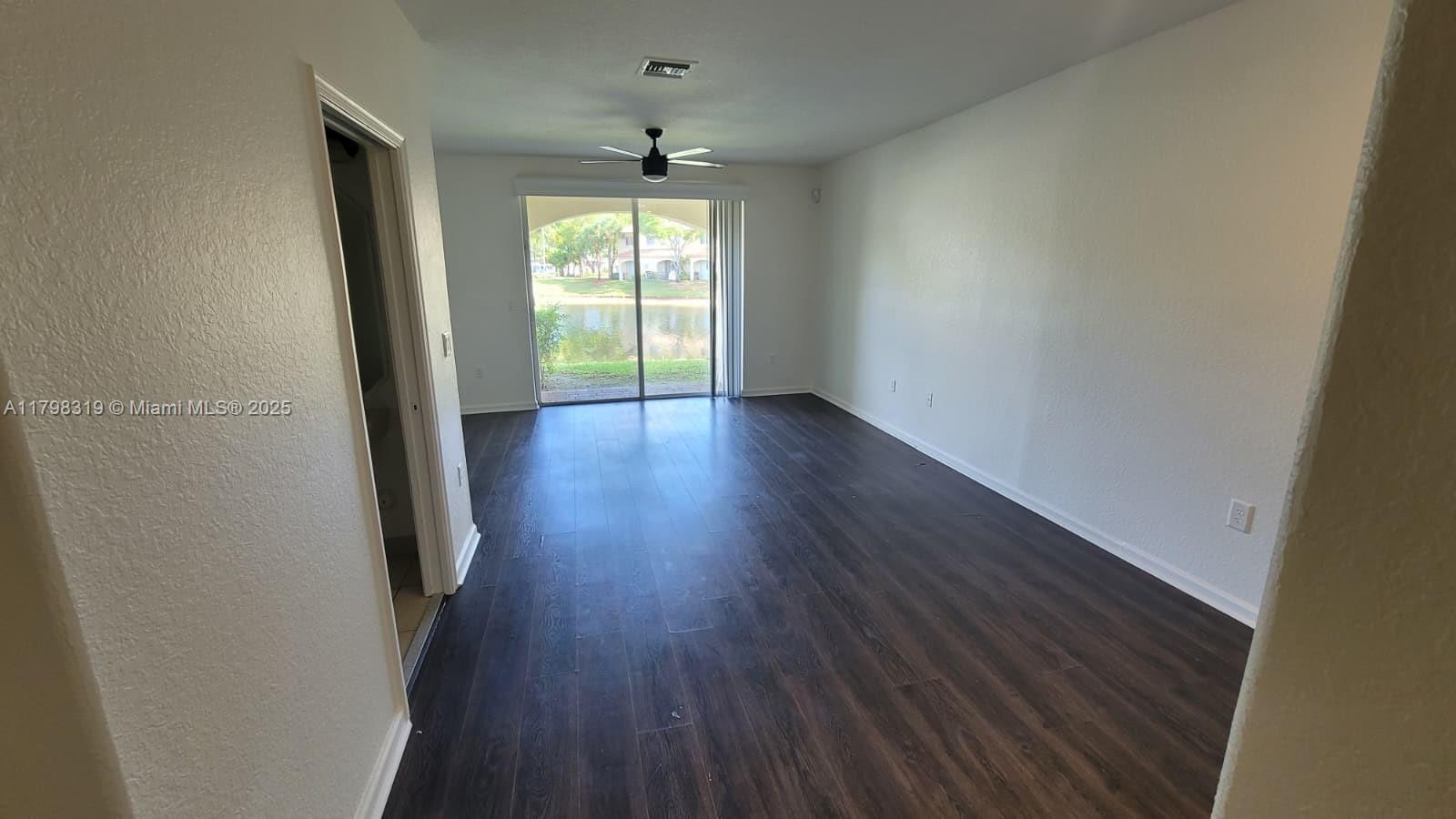 8353 Southwest 26 Th Street, Unit 104 Miramar, FL 33025 - Photo 13 of 14 wooden floor in an empty room with a window