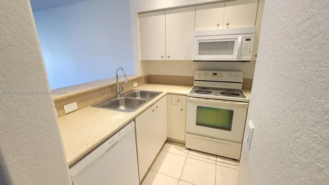 a kitchen with a stove microwave and sink