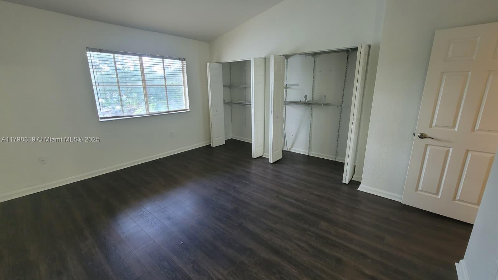 8353 Southwest 26 Th Street, Unit 104 Miramar, FL 33025 - Photo 5 of 14 an empty room with wooden floor and windows