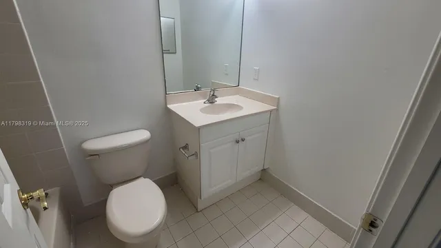a white toilet sitting next to a bathroom sink