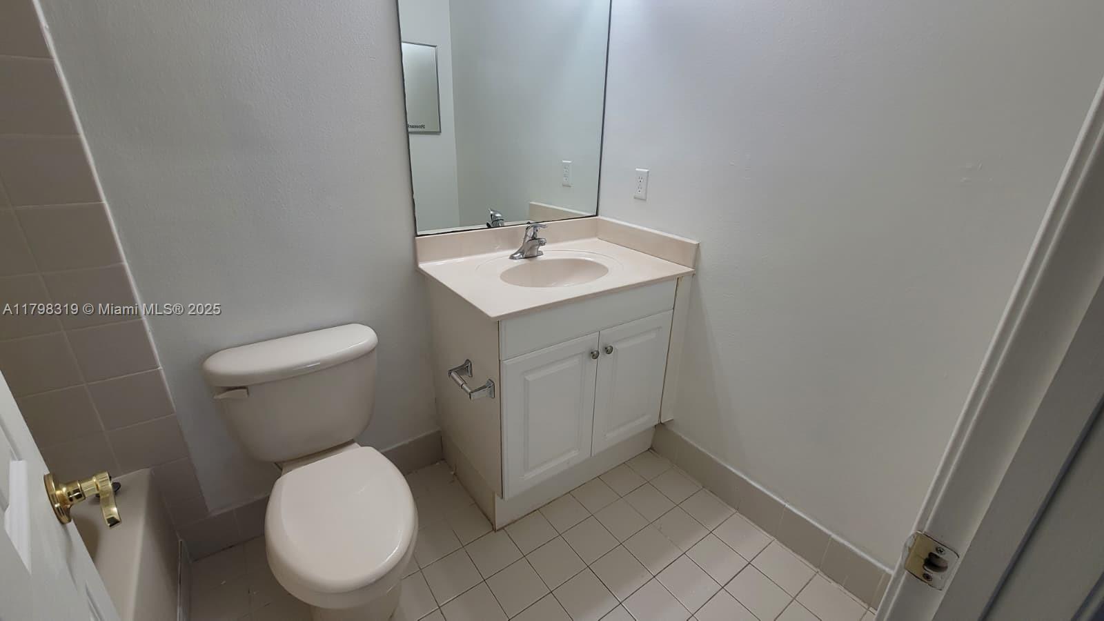8353 Southwest 26 Th Street, Unit 104 Miramar, FL 33025 - Photo 8 of 14 a white toilet sitting next to a bathroom sink