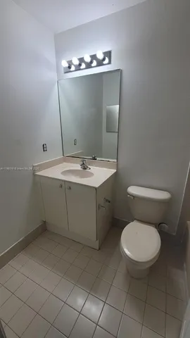 a bathroom with a sink a toilet and mirror