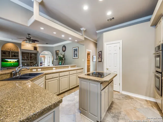 a kitchen with stainless steel appliances granite countertop a sink and a stove