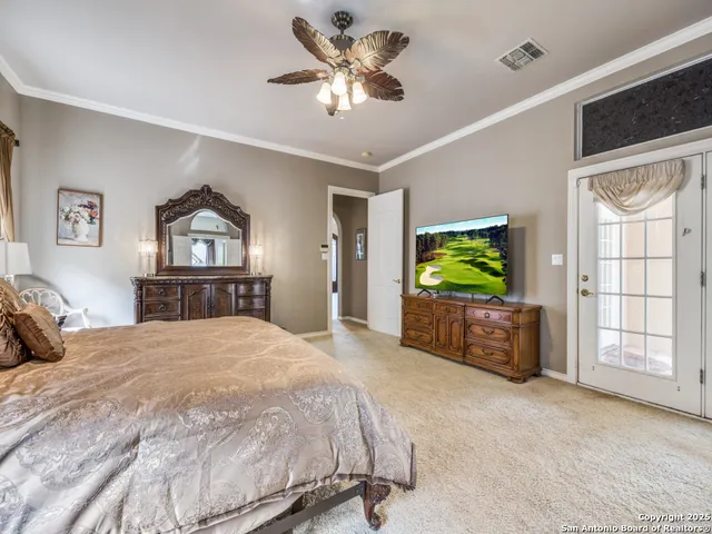 a bedroom with a balcony a bed and a flat screen tv