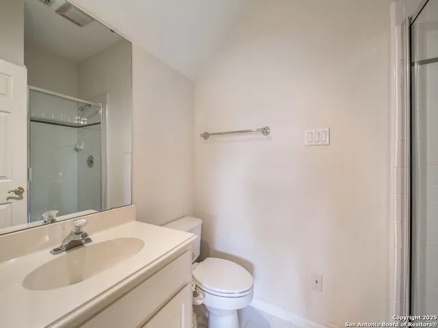 a bathroom with a sink toilet and a mirror