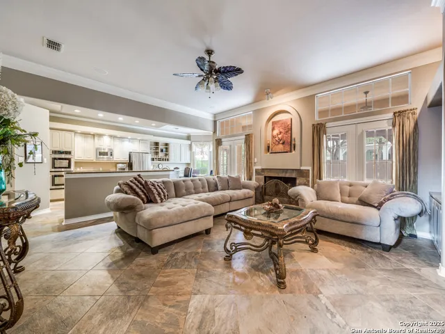 a living room with fireplace furniture and a chandelier
