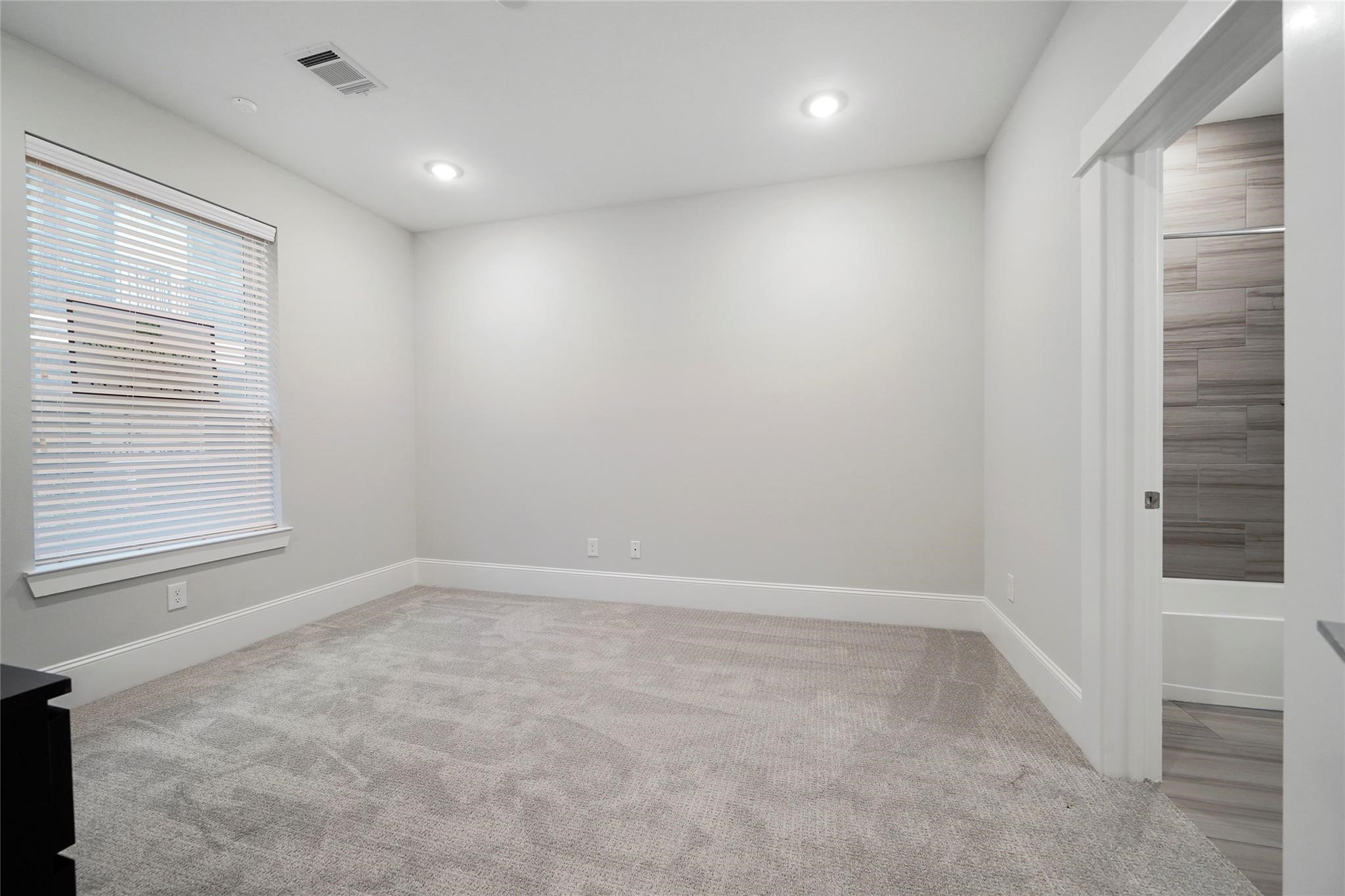 1268 North Post Oak Road, Unit A Houston, TX 77055 - Photo 17 of 32 an empty room with a window