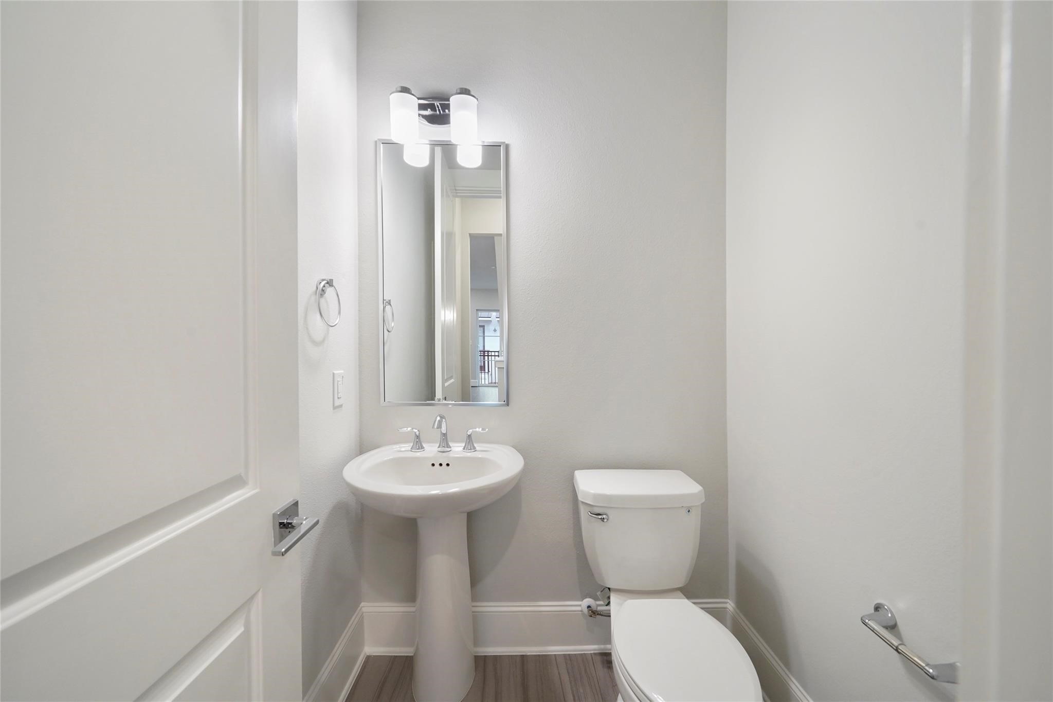 1268 North Post Oak Road, Unit A Houston, TX 77055 - Photo 18 of 32 a bathroom with a toilet sink and mirror