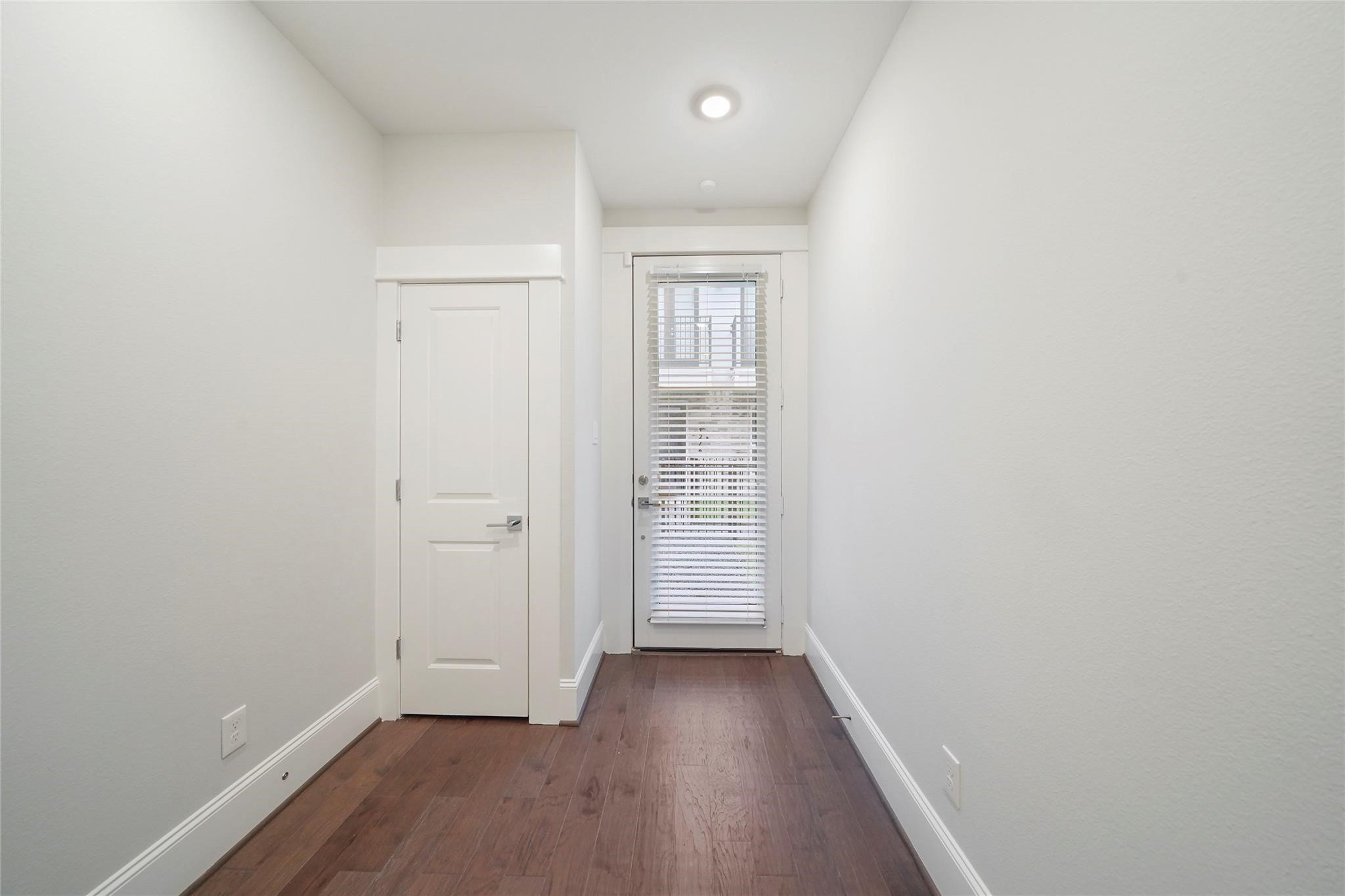 1268 North Post Oak Road, Unit A Houston, TX 77055 - Photo 2 of 32 a view of a hallway with wooden floor