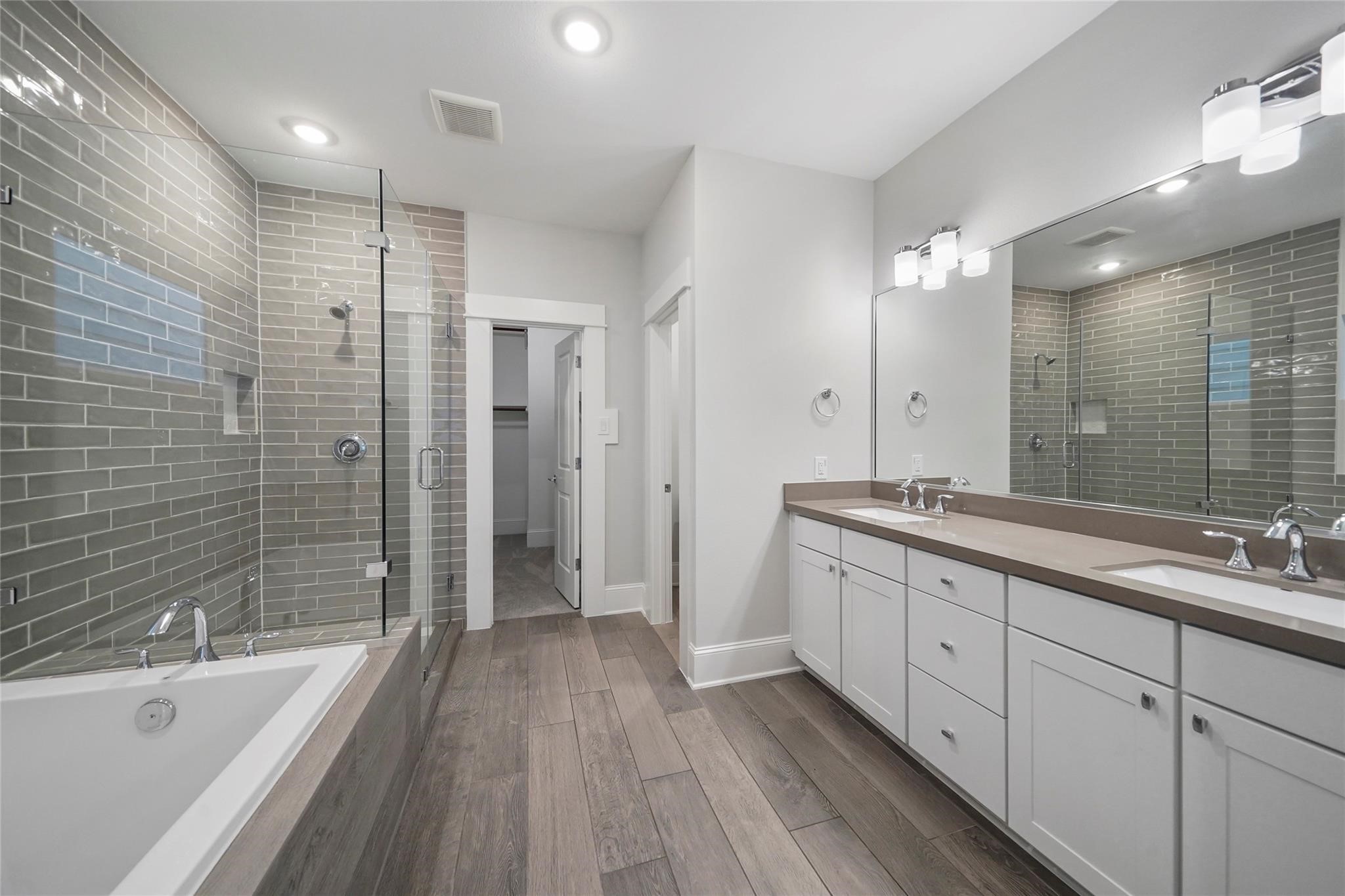 1268 North Post Oak Road, Unit A Houston, TX 77055 - Photo 26 of 32 a bathroom with a double vanity sink a large mirror and shower