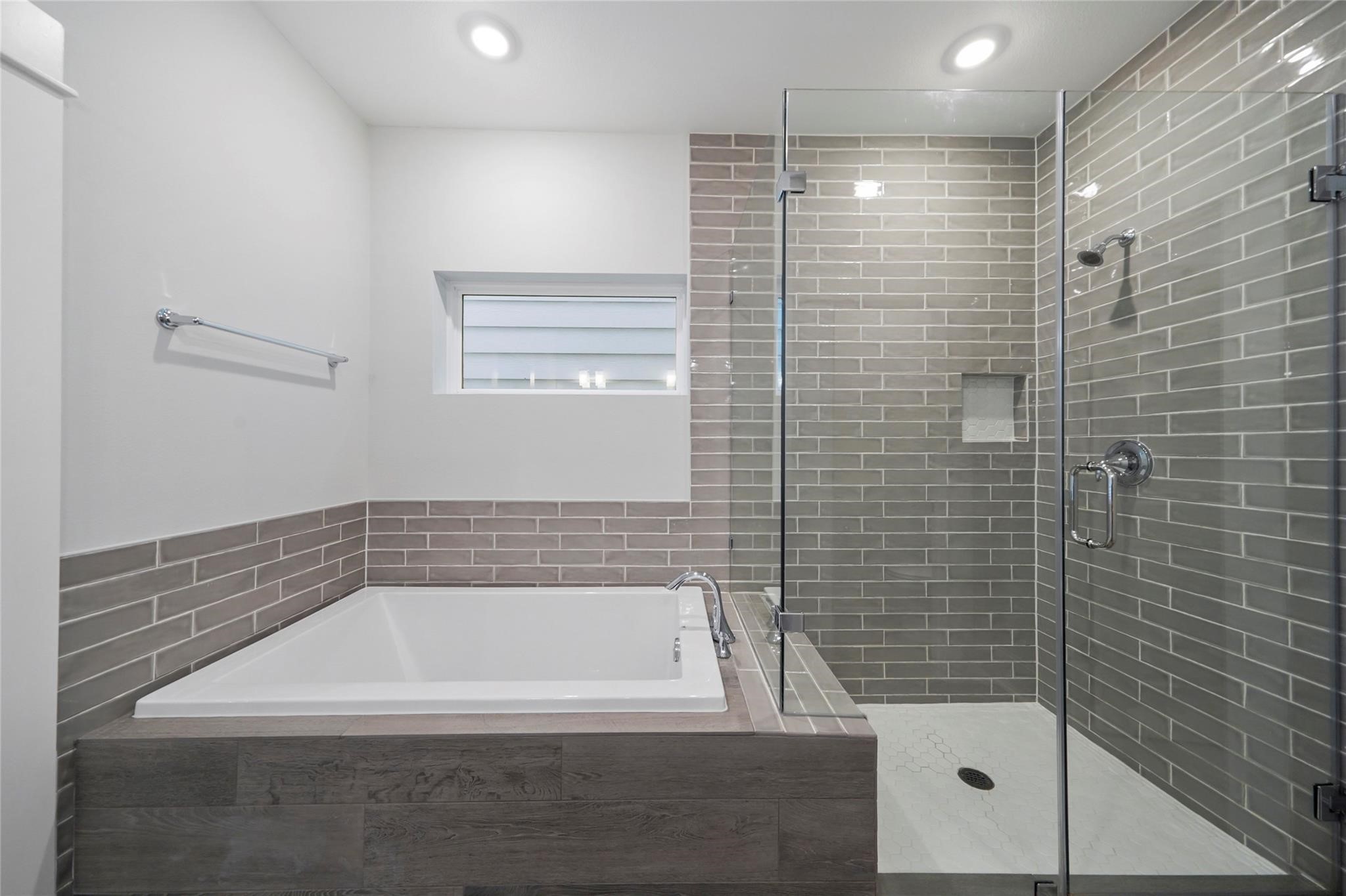 1268 North Post Oak Road, Unit A Houston, TX 77055 - Photo 28 of 32 a bathroom with a bathtub and shower