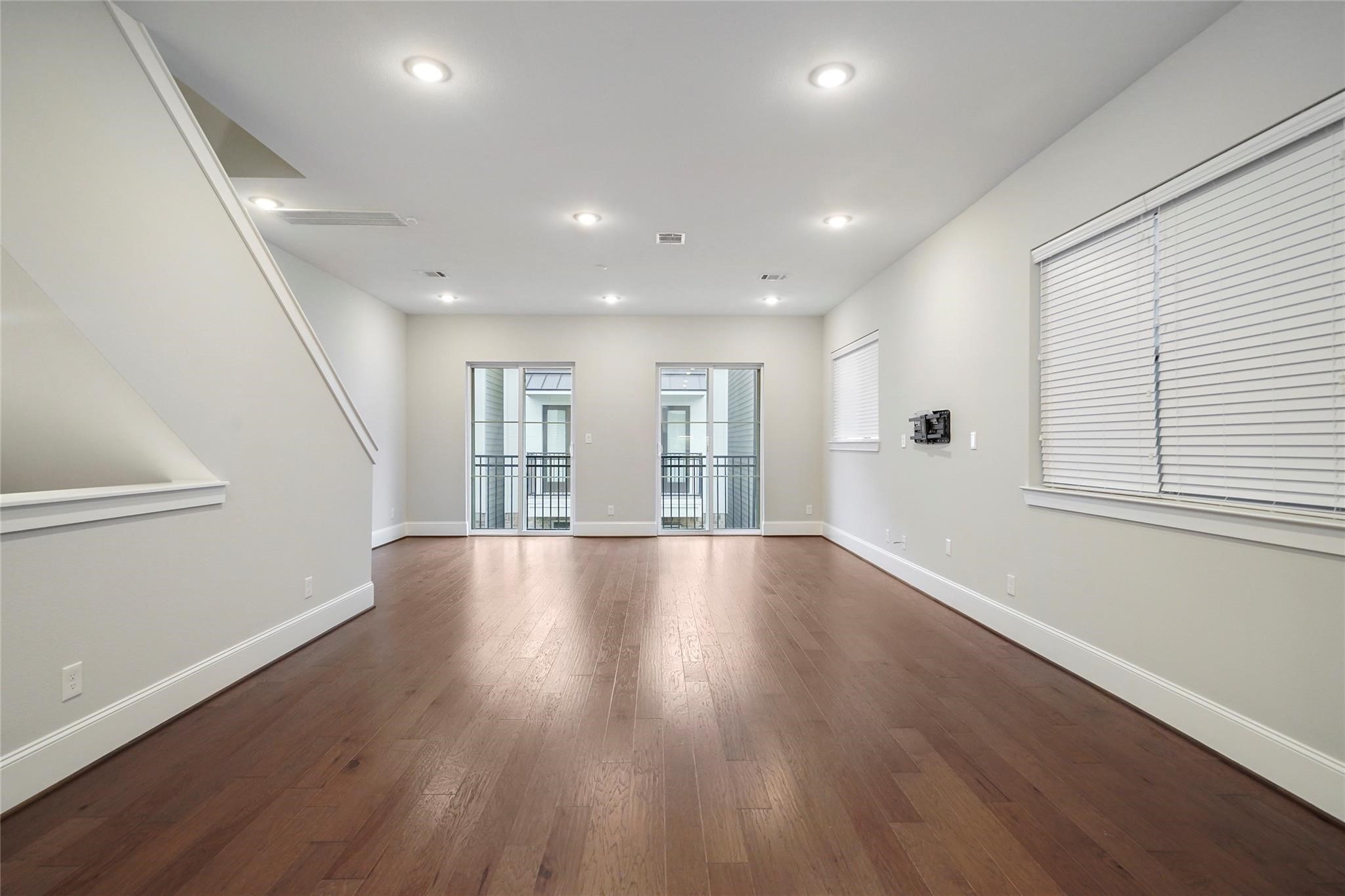1268 North Post Oak Road, Unit A Houston, TX 77055 - Photo 9 of 32 a view of empty room with wooden floor and fan