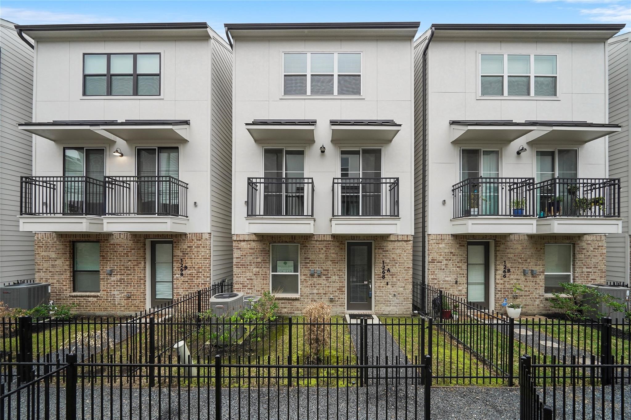 1268 North Post Oak Road, Unit A Houston, TX 77055 - Photo 10 of 32 a front view of a house with a balcony
