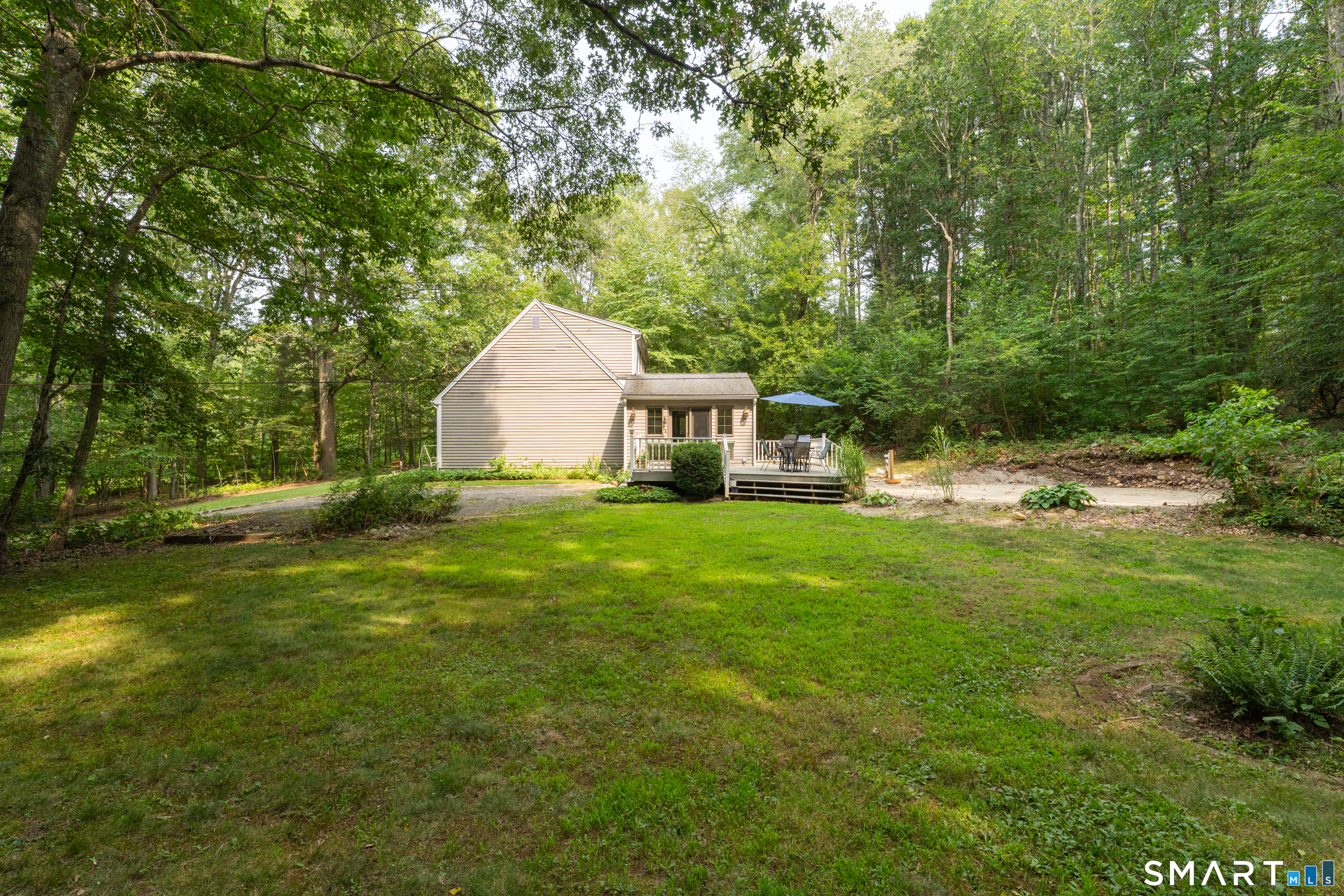 91 Whippoorwill Road Old Lyme, CT 06371 - Photo 4 of 25 Bring your creativity to reimagine the sandy area the pool used to be located in.