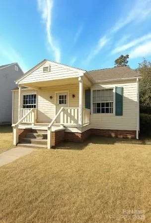 a view of house with yard