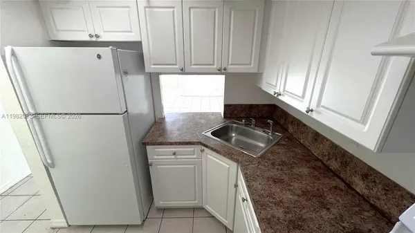 a white refrigerator freezer sitting inside of a kitchen