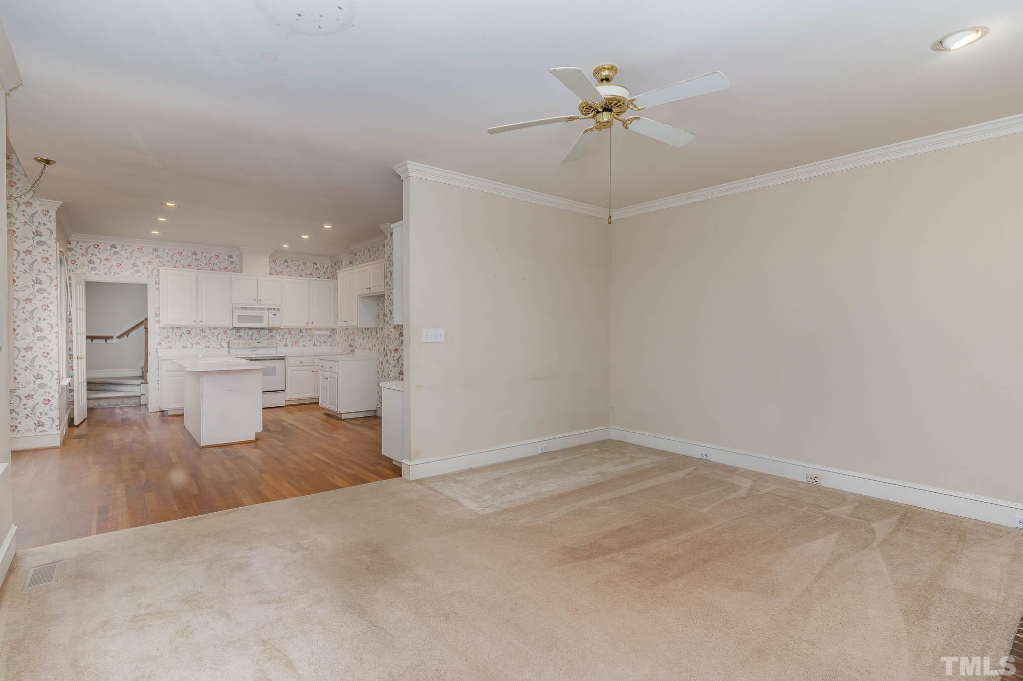 8121 Glenbrittle Way Raleigh, NC 27615 - Photo 11 of 35 a view of a kitchen with a sink and a chandelier fan