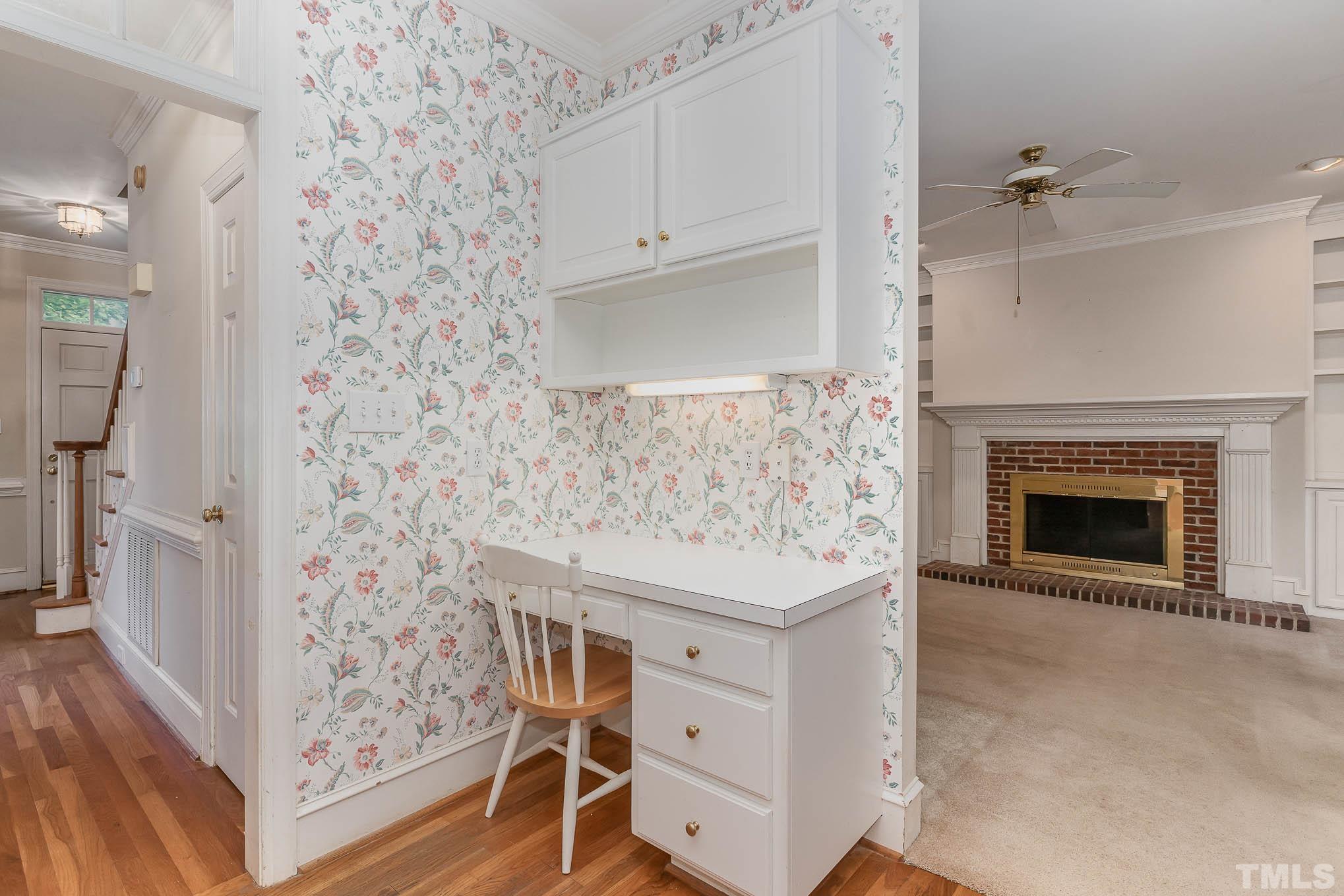 8121 Glenbrittle Way Raleigh, NC 27615 - Photo 12 of 35 a view of a livingroom with wooden floor and a fireplace
