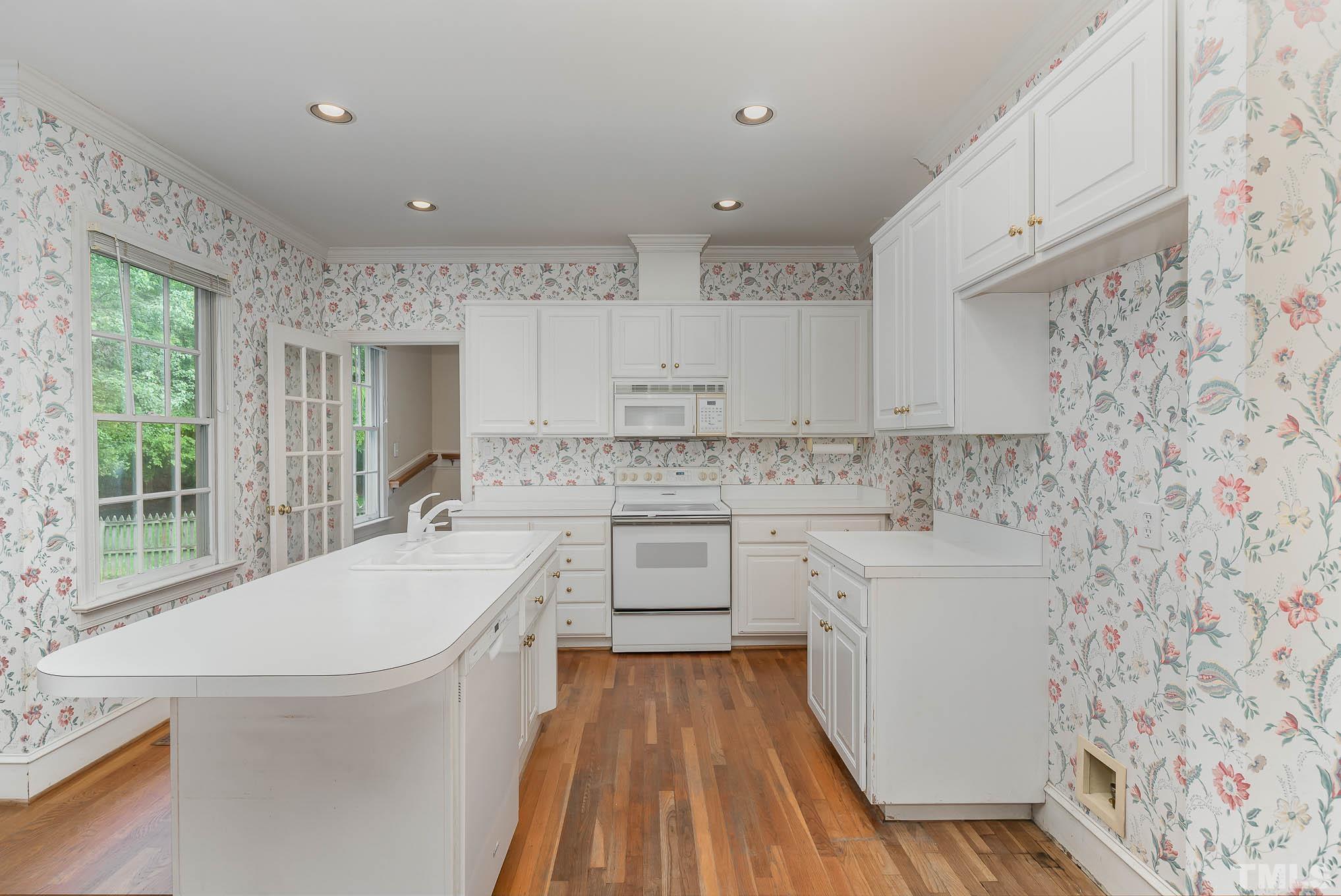8121 Glenbrittle Way Raleigh, NC 27615 - Photo 15 of 35 a spacious bathroom with a sink a large mirror and a bathtub