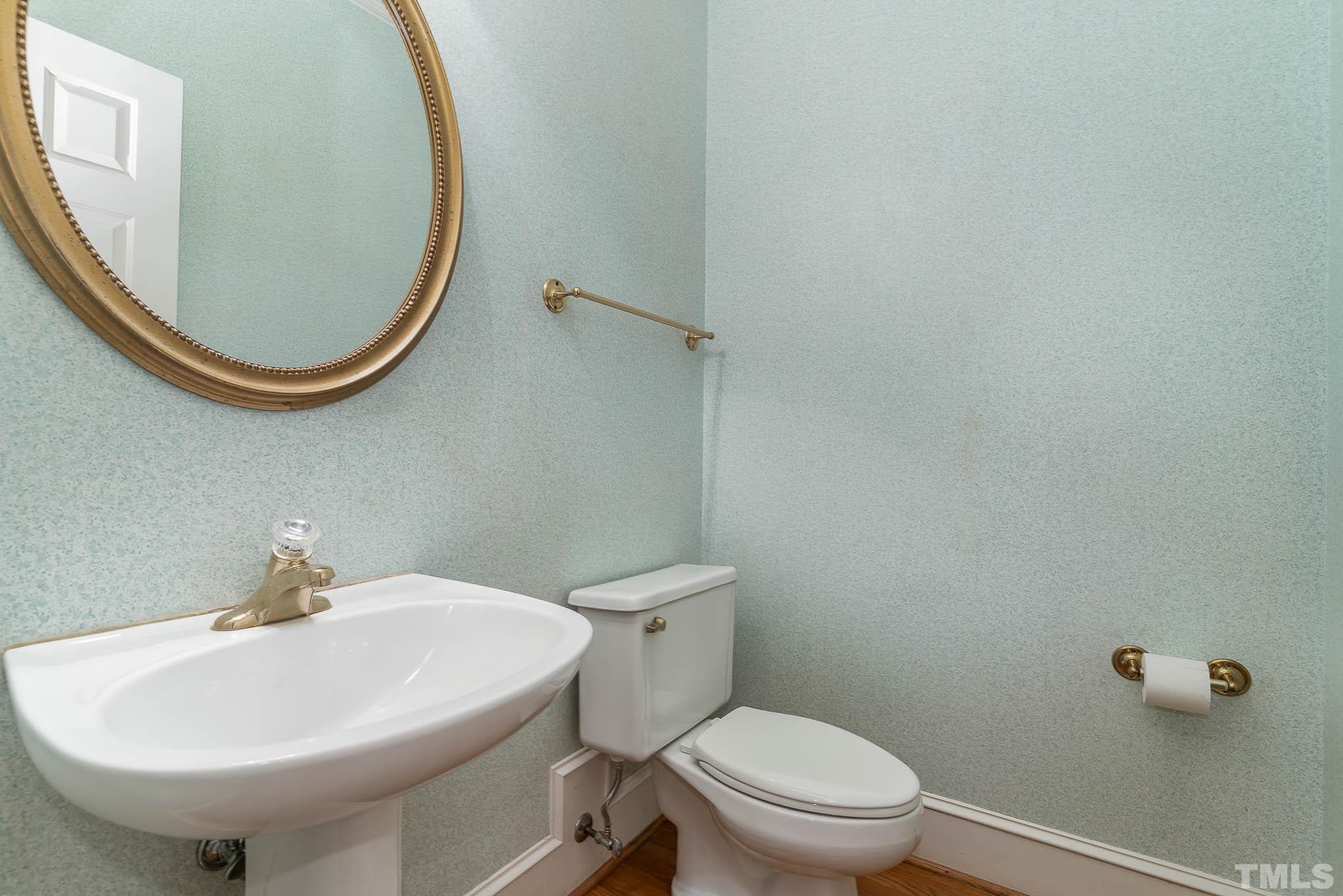8121 Glenbrittle Way Raleigh, NC 27615 - Photo 17 of 35 a bathroom with a sink a toilet and a mirror