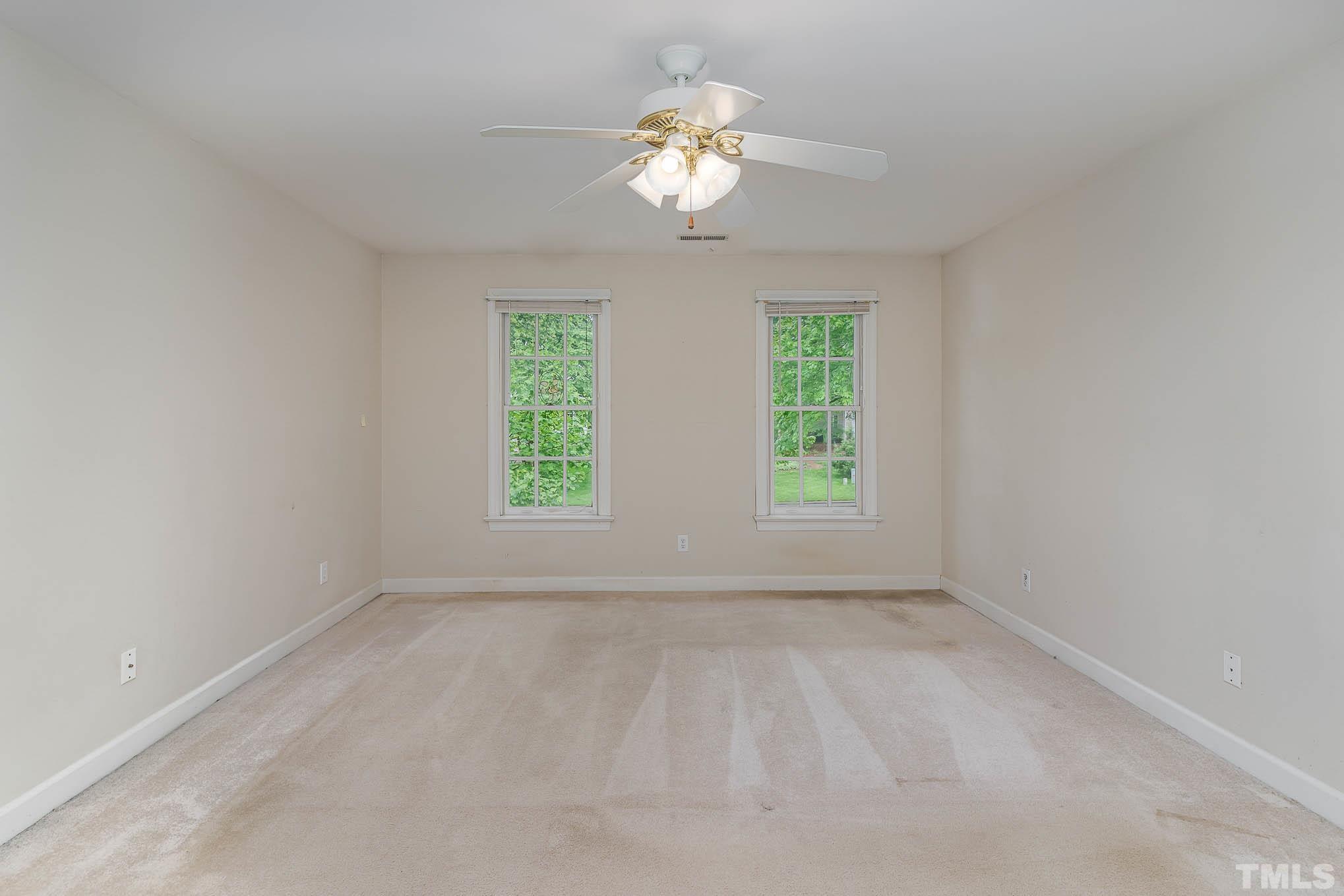 8121 Glenbrittle Way Raleigh, NC 27615 - Photo 18 of 35 wooden floor in an empty room with a window