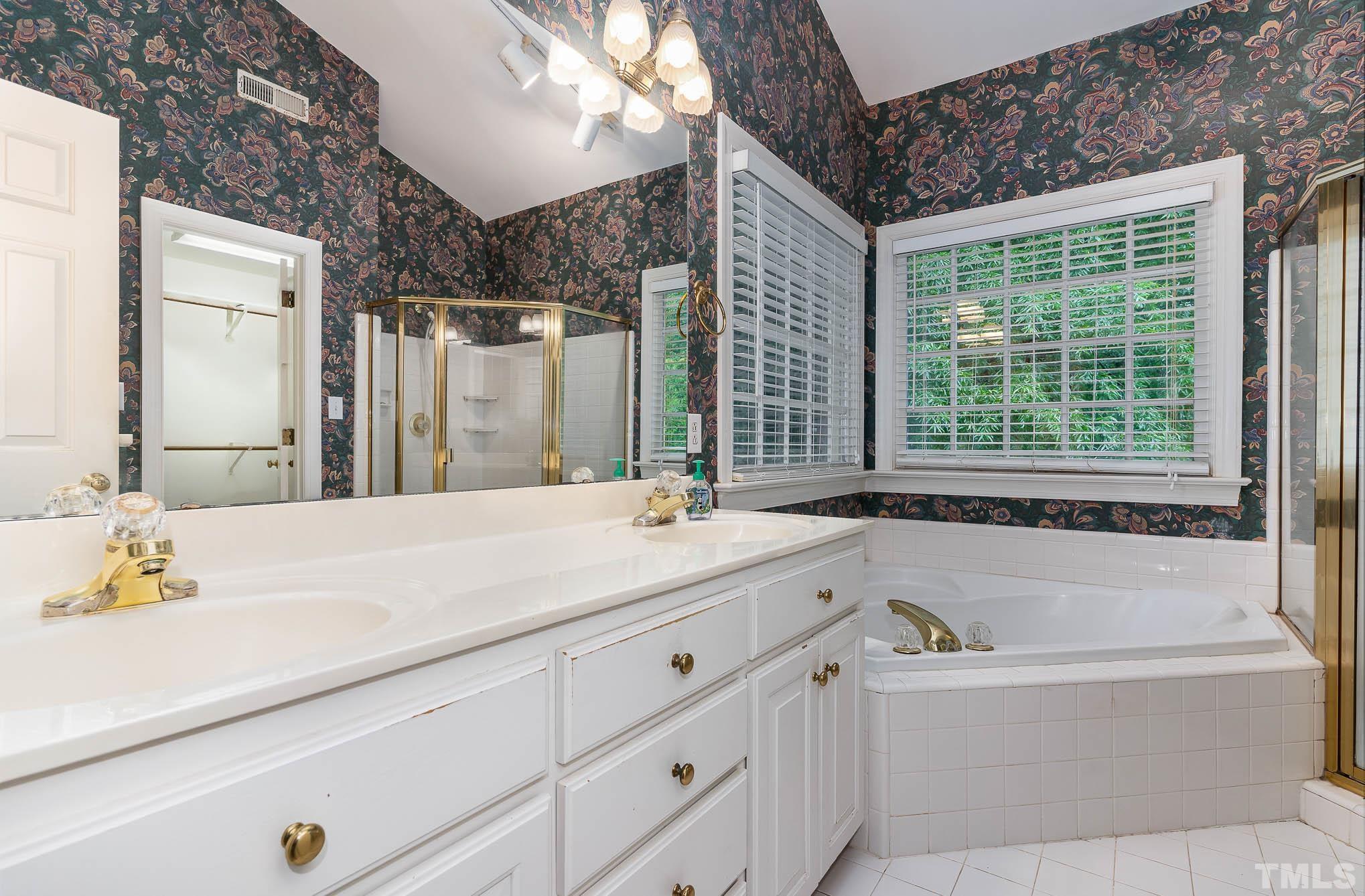 8121 Glenbrittle Way Raleigh, NC 27615 - Photo 20 of 35 a bathroom with a tub sink and mirror