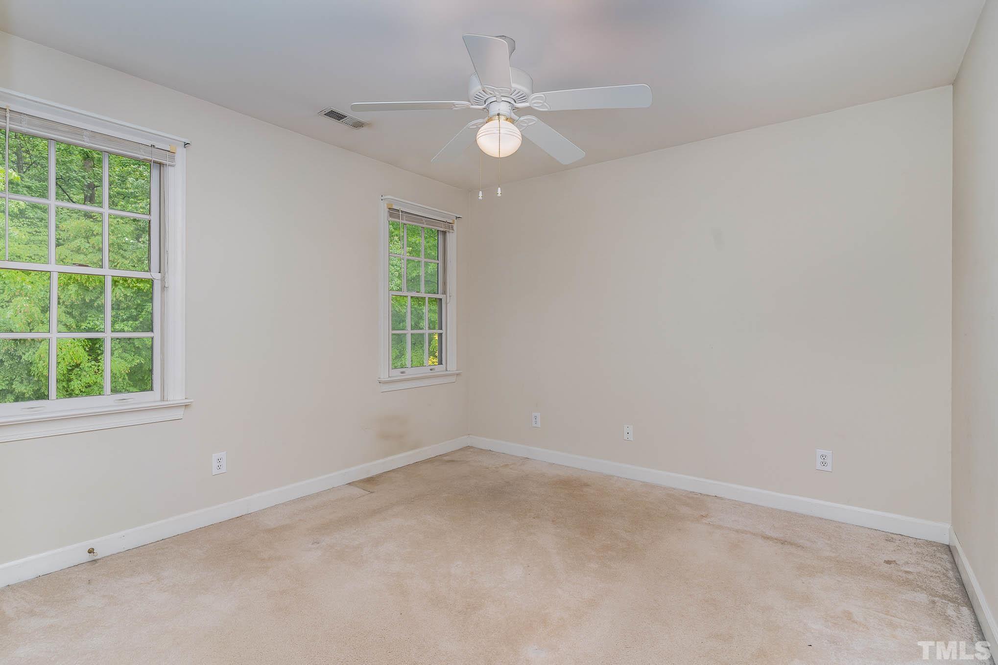 8121 Glenbrittle Way Raleigh, NC 27615 - Photo 25 of 35 an empty room with a window and a fan