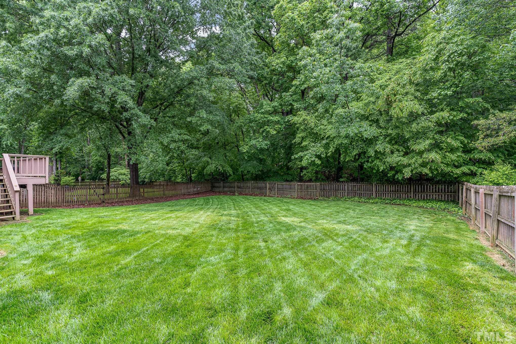 8121 Glenbrittle Way Raleigh, NC 27615 - Photo 30 of 35 a view of a backyard with a trees