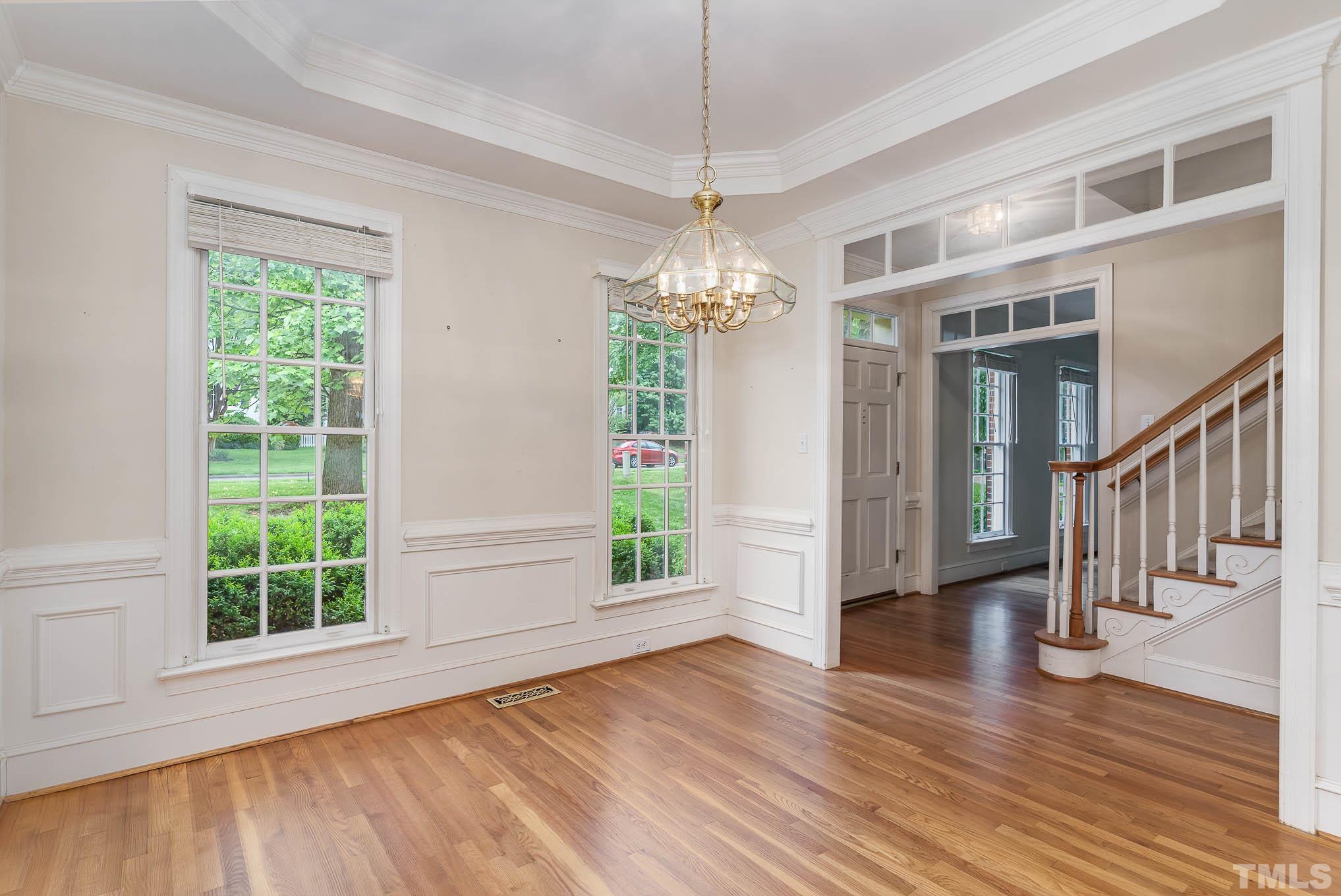 8121 Glenbrittle Way Raleigh, NC 27615 - Photo 5 of 35 a view of an empty room with wooden floor and a window