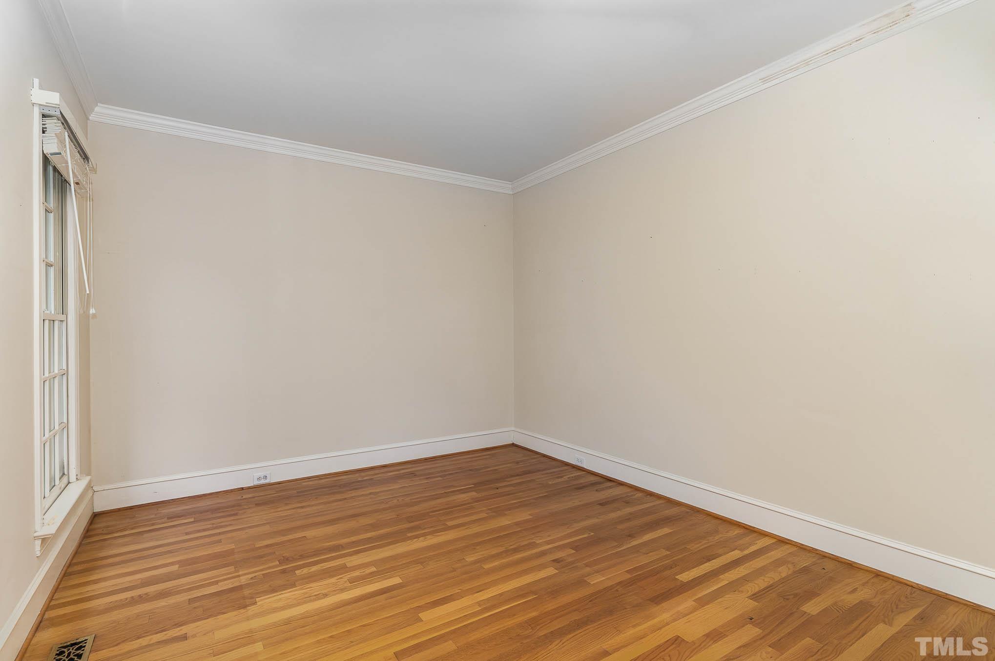 8121 Glenbrittle Way Raleigh, NC 27615 - Photo 6 of 35 a view of an empty room with wooden floor