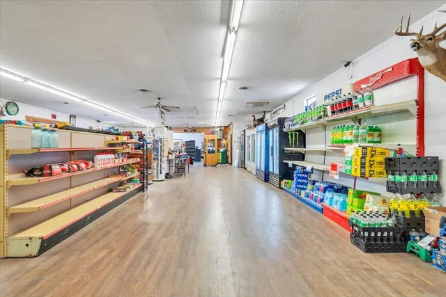 a living room with furniture and kitchen view