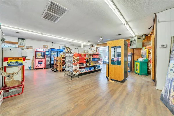 a kitchen with a refrigerator and a stove top oven