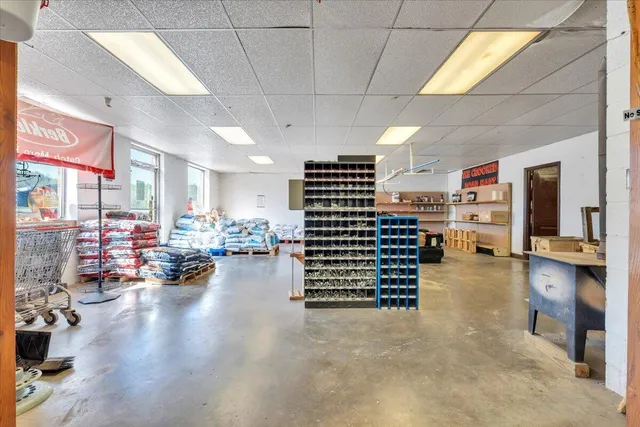 a bed room with a bed and a painting on the wall