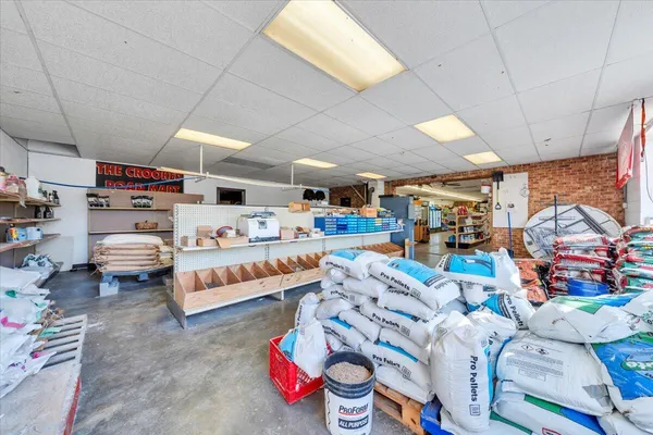 a view of a big room with wooden floor and windows