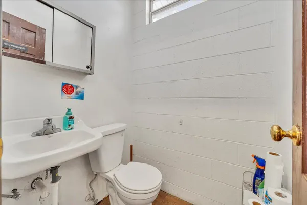a view of a livingroom with wooden floor and a ceiling fan
