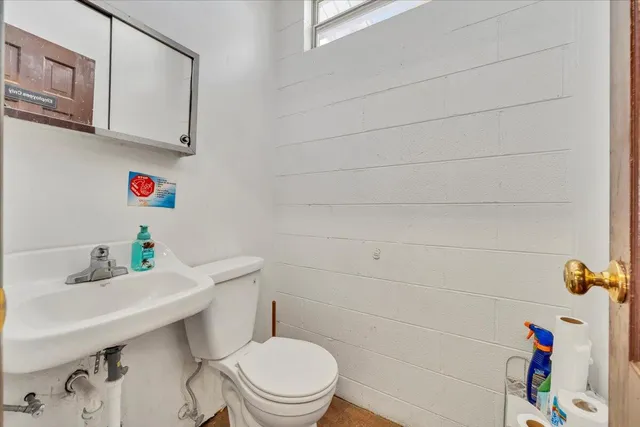 a view of a livingroom with wooden floor and a ceiling fan