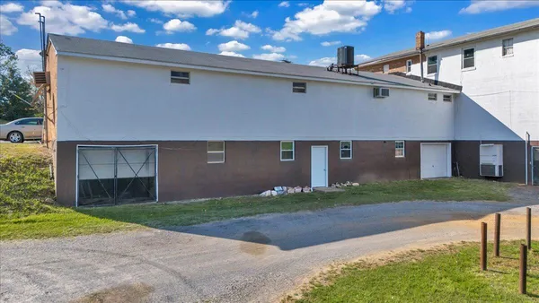 a view of a house with a yard and table