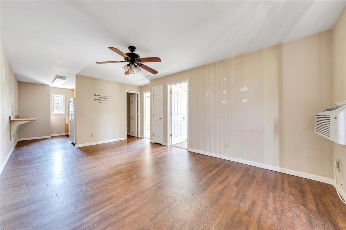14189 Franklin Street Ferrum, VA 24088 - Photo 77 of 95 a view of a livingroom with wooden floor and a ceiling fan