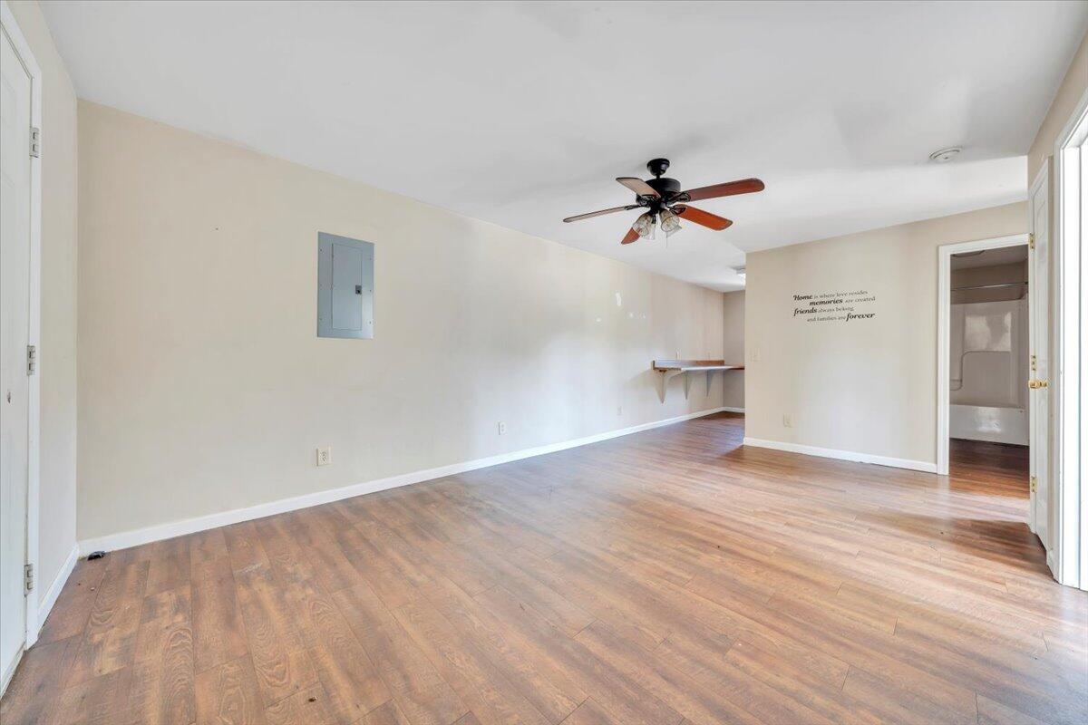 14189 Franklin Street Ferrum, VA 24088 - Photo 79 of 95 an empty room with wooden floor and ceiling fan