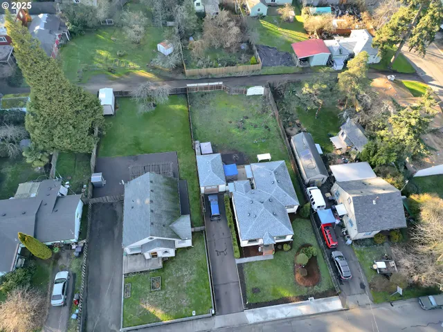 an aerial view of residential houses with outdoor space and street view