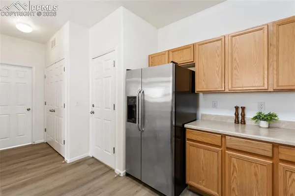 a kitchen with stainless steel appliances granite countertop a refrigerator and a sink