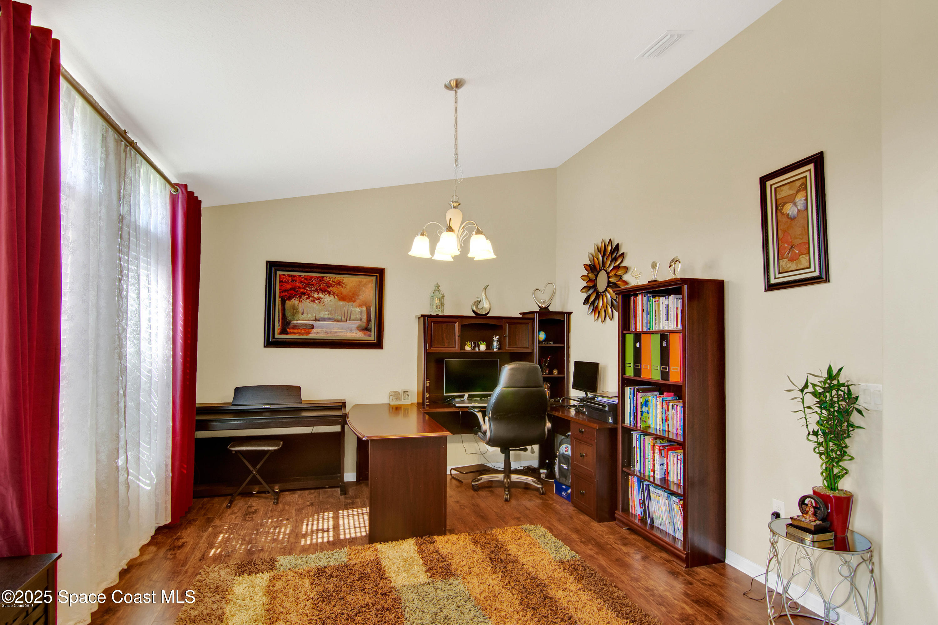 909 Fiddleleaf Circle Melbourne, FL 32904 - Photo 12 of 15 a view of a workspace with furniture and a potted plant