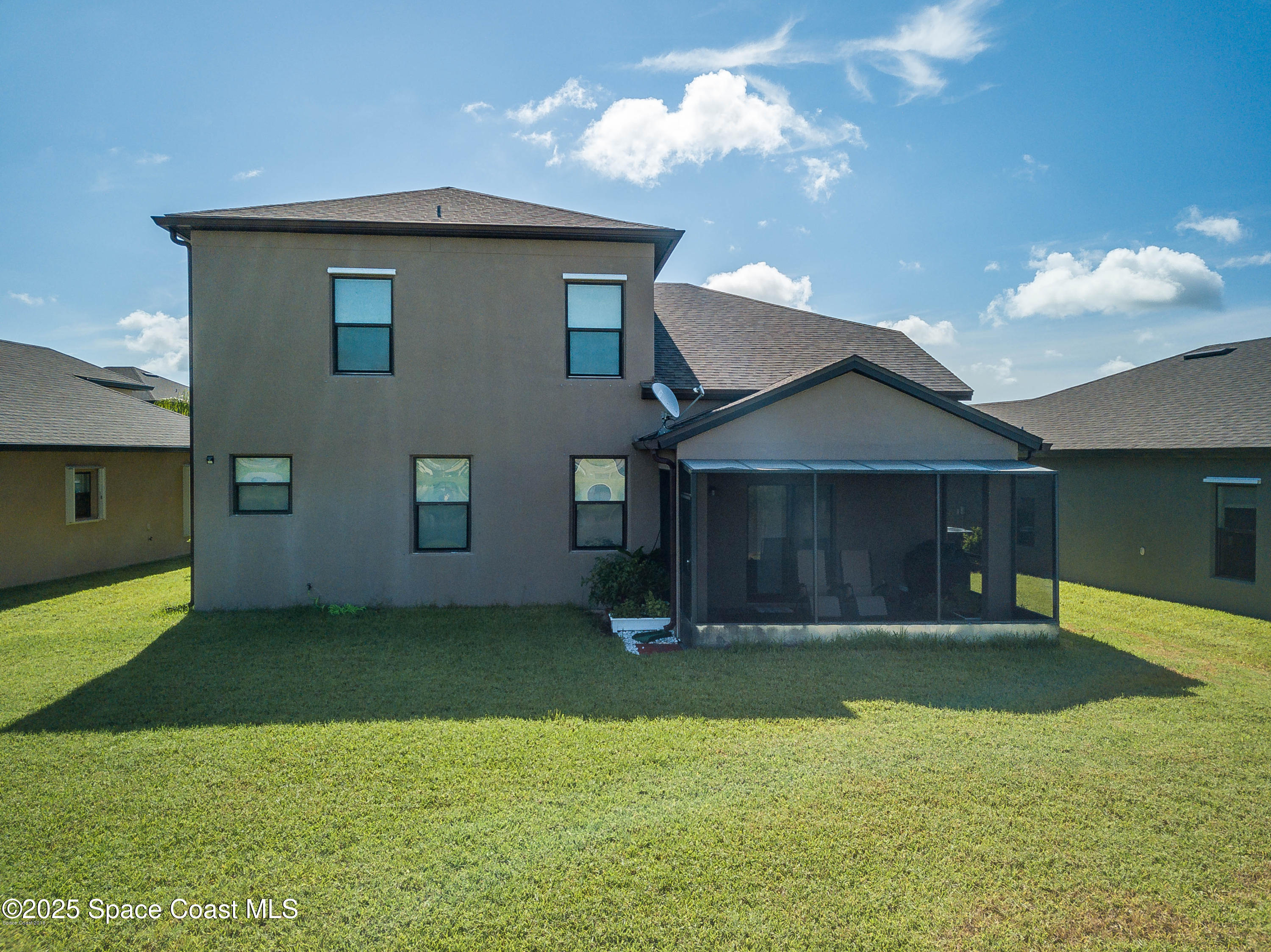 909 Fiddleleaf Circle Melbourne, FL 32904 - Photo 13 of 15 a front view of a house with a yard