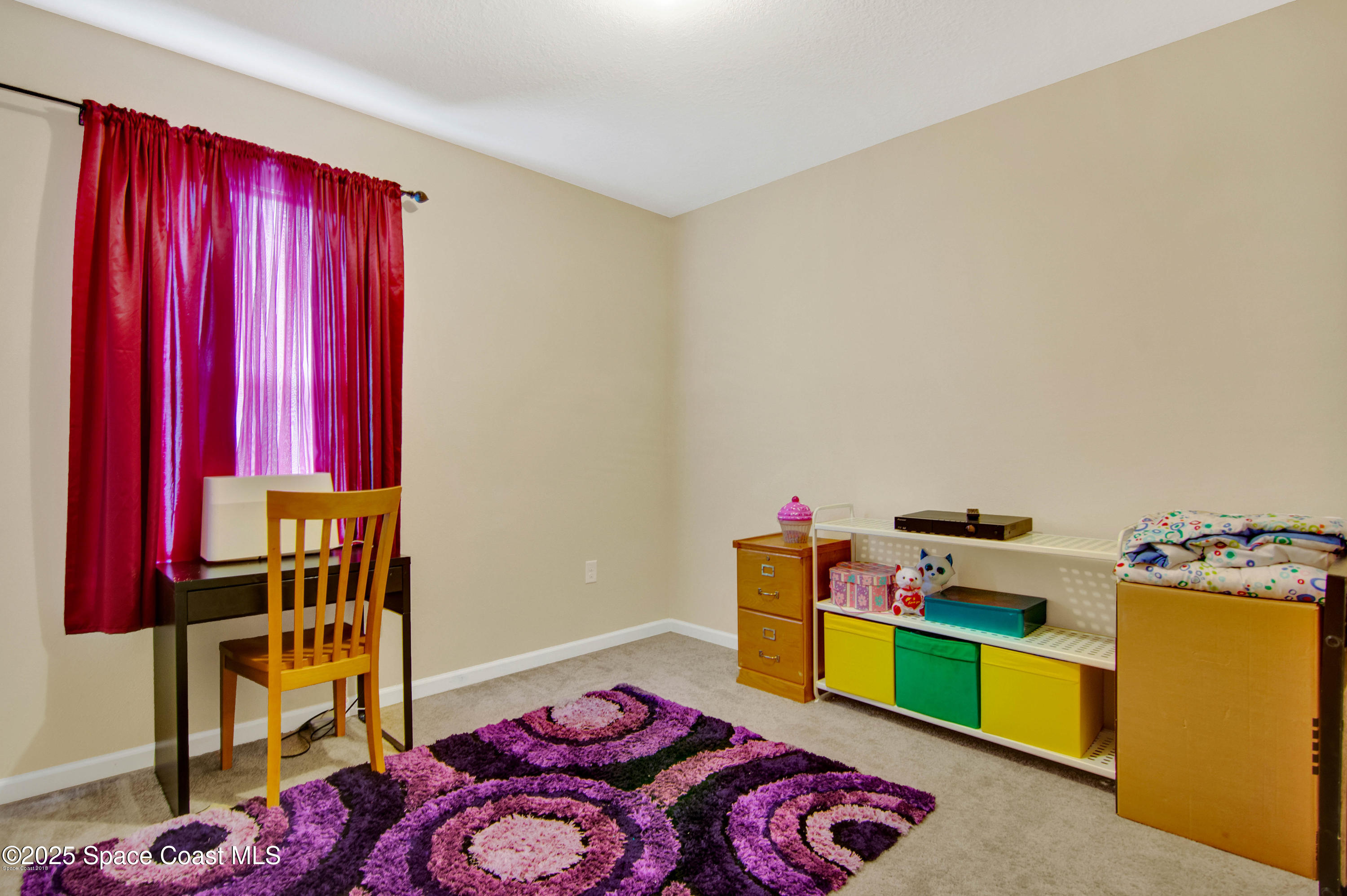 909 Fiddleleaf Circle Melbourne, FL 32904 - Photo 4 of 15 a bedroom with a bed and a chandelier