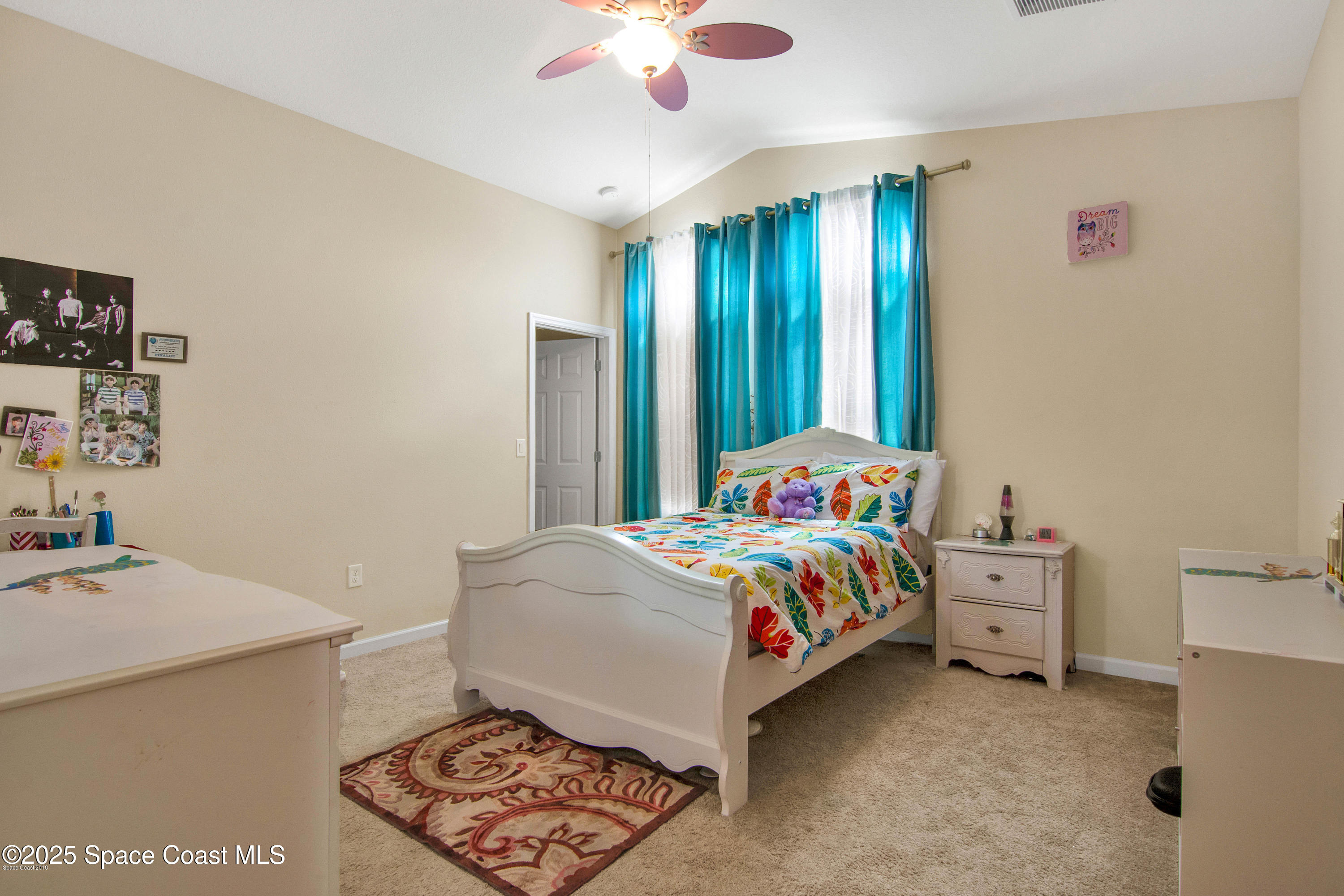 909 Fiddleleaf Circle Melbourne, FL 32904 - Photo 7 of 15 a bedroom with a bed and a chandelier