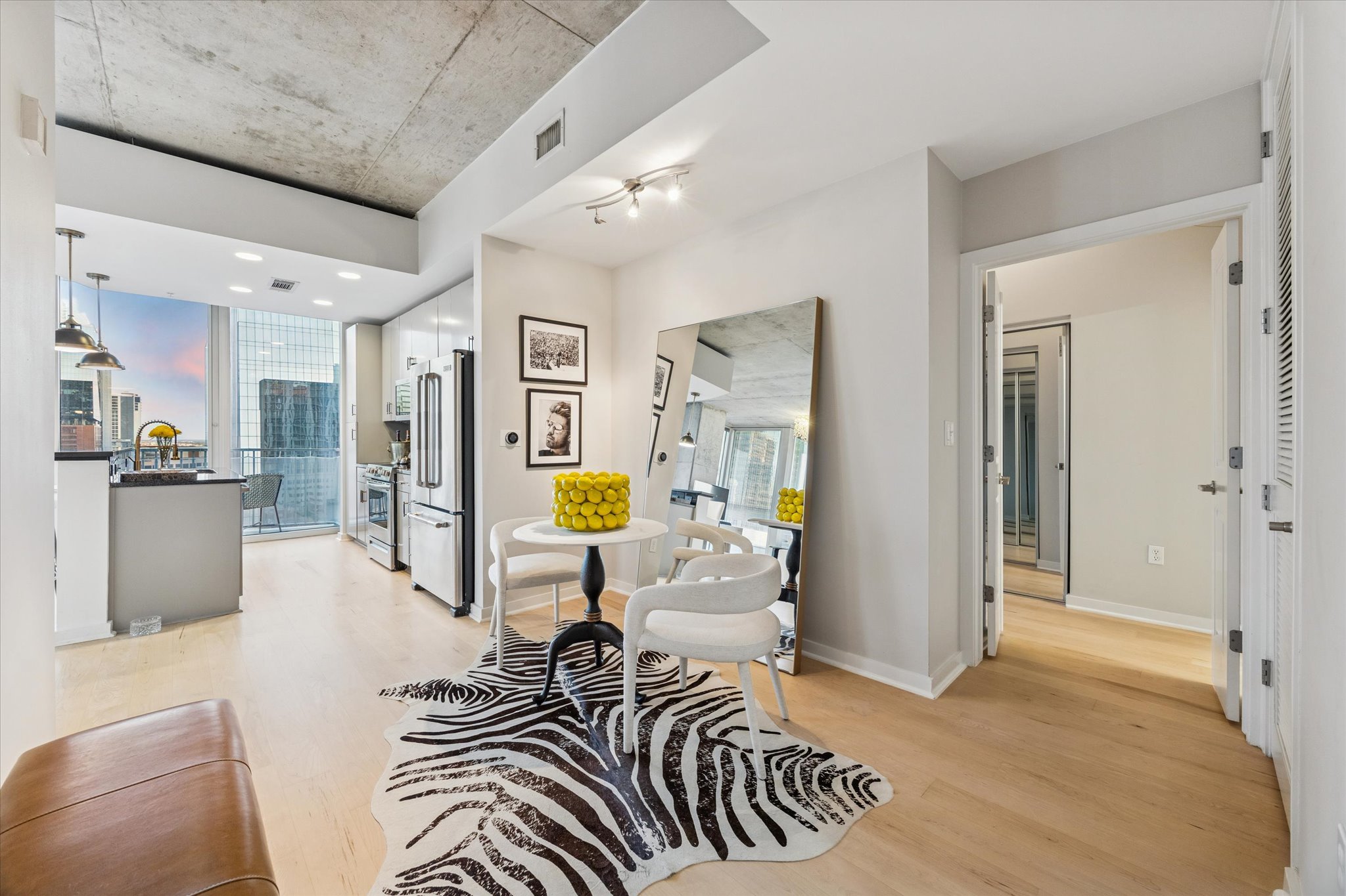 360 Nueces Street, Unit 1417 Austin, TX 78701 - Photo 12 of 39 a view of a hallway with dining area and glass door