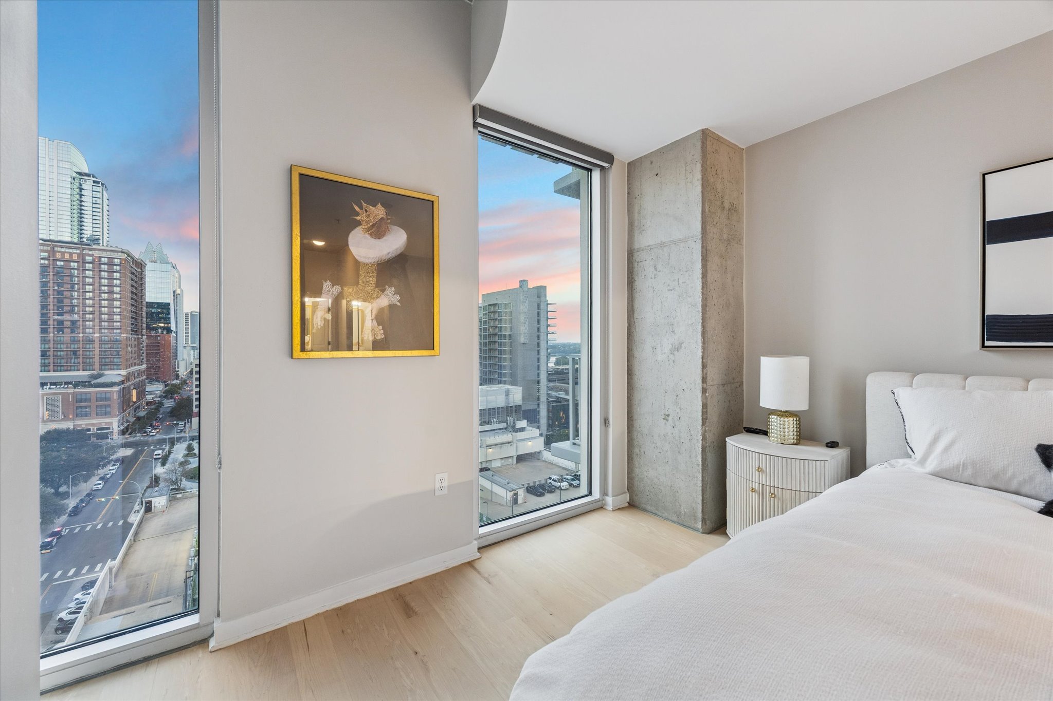 360 Nueces Street, Unit 1417 Austin, TX 78701 - Photo 16 of 39 a bedroom with a balcony a bed and a painting on the wall