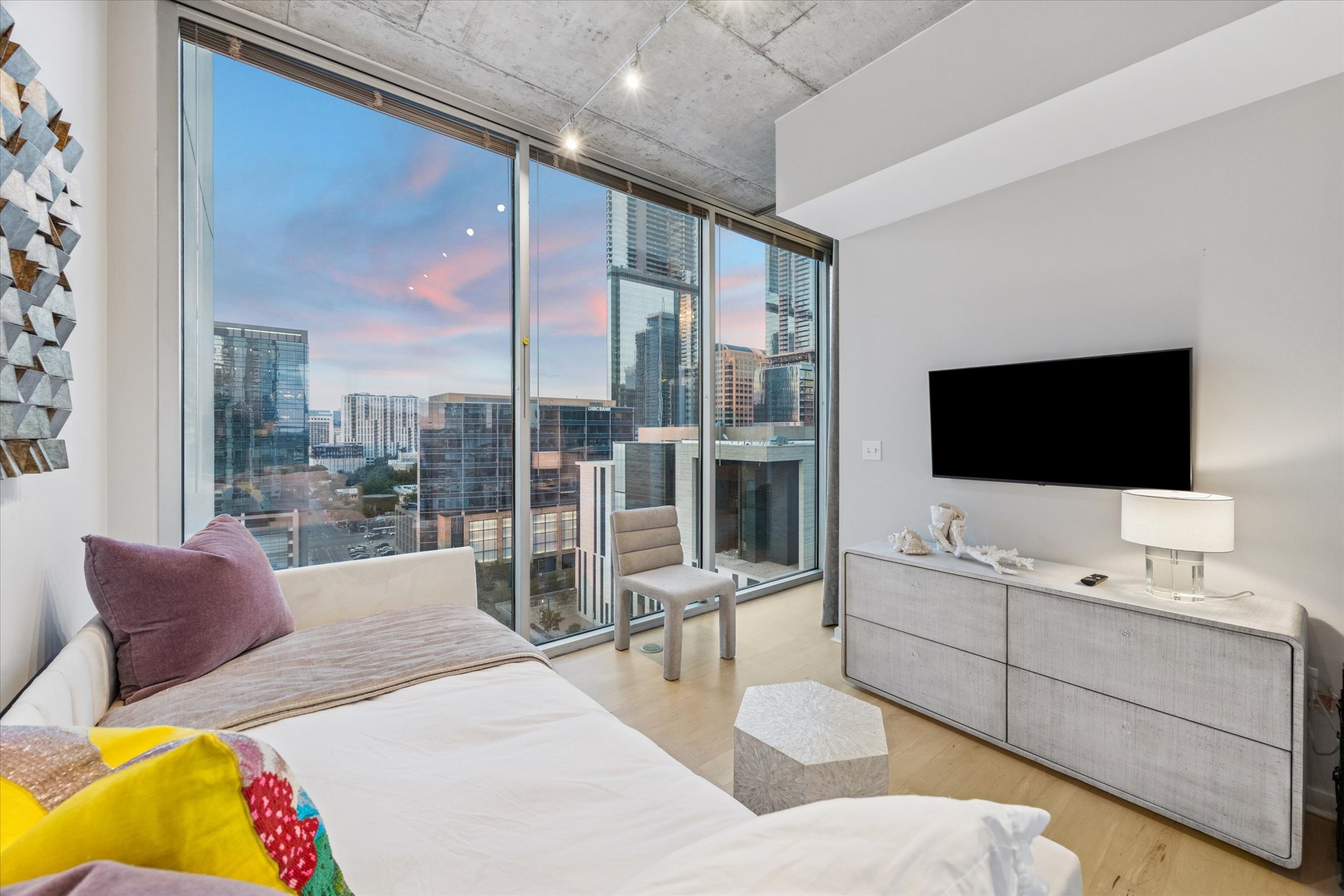 360 Nueces Street, Unit 1417 Austin, TX 78701 - Photo 24 of 39 a living room with furniture a flat screen tv and a floor to ceiling window