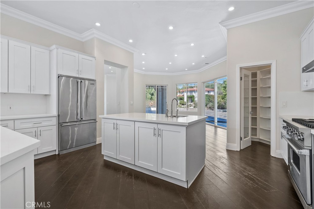 166 Dapplegray Road Bell Canyon, CA 91307 - Photo 12 of 57 a kitchen with cabinets and wooden floor