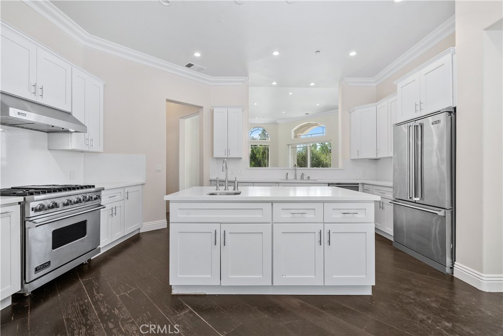 166 Dapplegray Road Bell Canyon, CA 91307 - Photo 13 of 57 a kitchen with white cabinets and stainless steel appliances